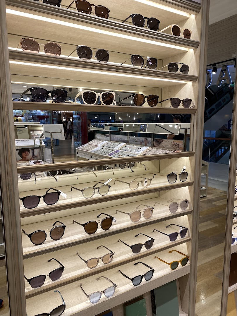 A well-lit display shelf showcasing a wide variety of stylish eyeglasses and sunglasses at OWNDAYS.
