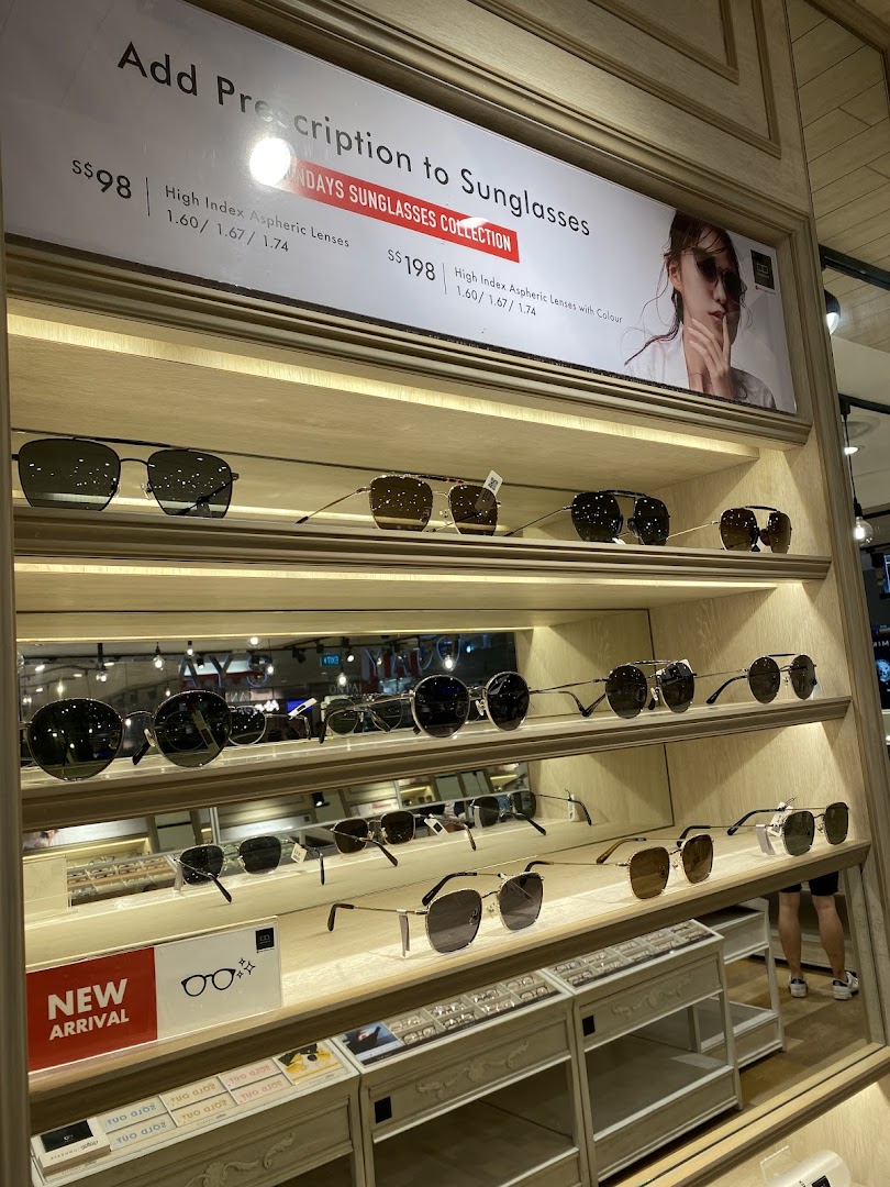A display of various sunglasses and a promotional sign for prescription lenses at OWNDAYS.