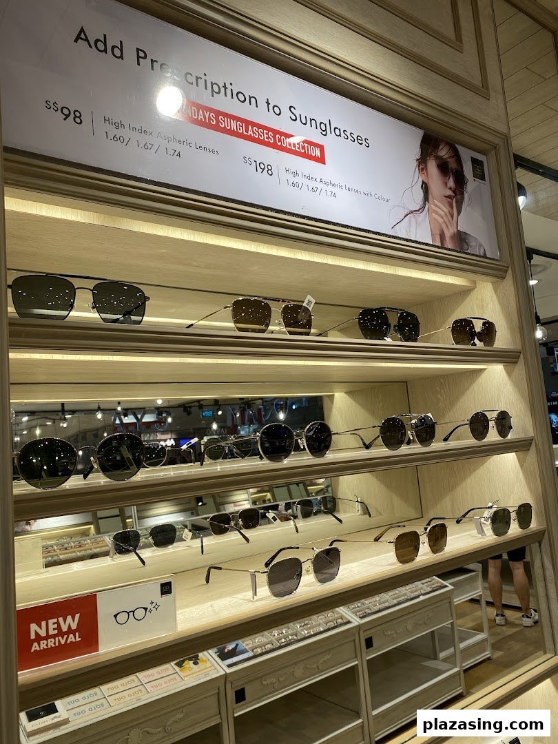 A display of various sunglasses and a promotional sign for prescription lenses at OWNDAYS.
