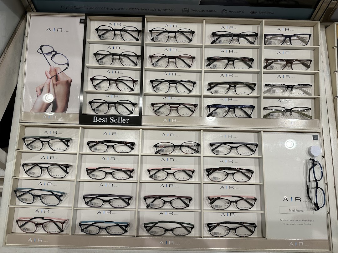 A retail display wall showcasing a wide selection of 'AIR' brand eyeglasses, including 'Best Seller' models.