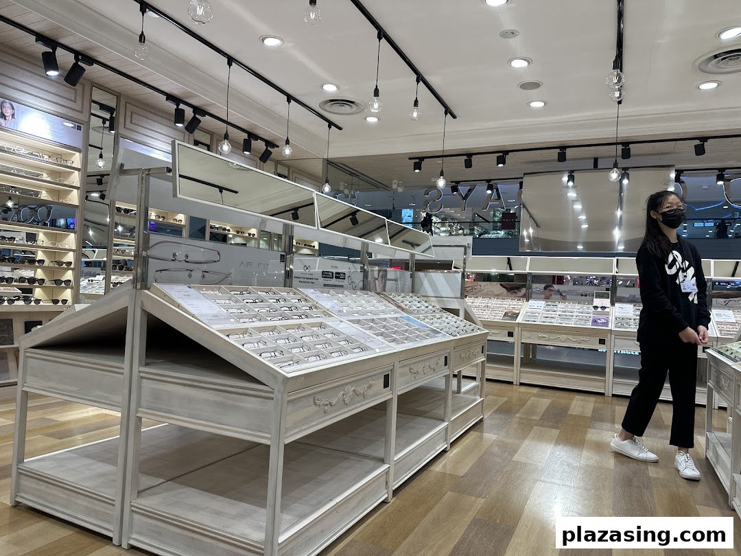 Interior view of OWNDAYS, showcasing numerous eyeglasses on display and a customer browsing the selection.