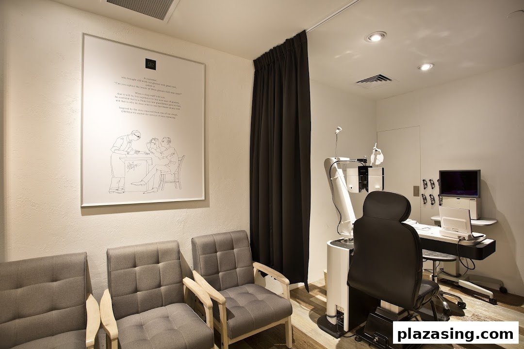 An interior view of an optical shop's eye examination room with waiting chairs and modern equipment.