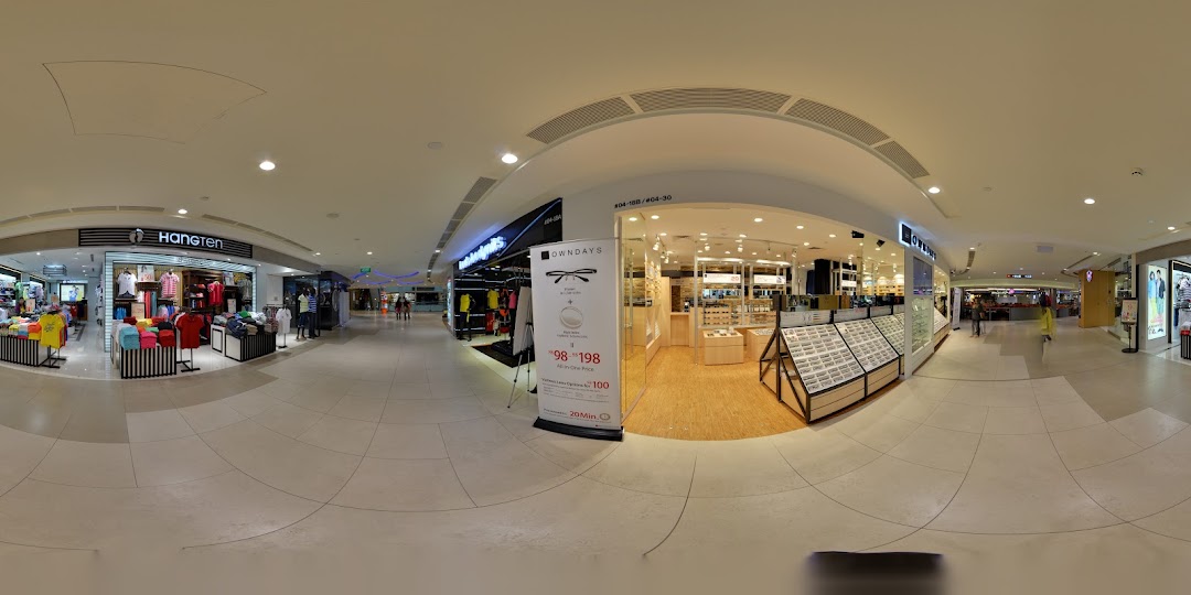 A wide-angle view of the OWNDAYS eyewear shop entrance in Plaza Singapura, showcasing its modern interior.