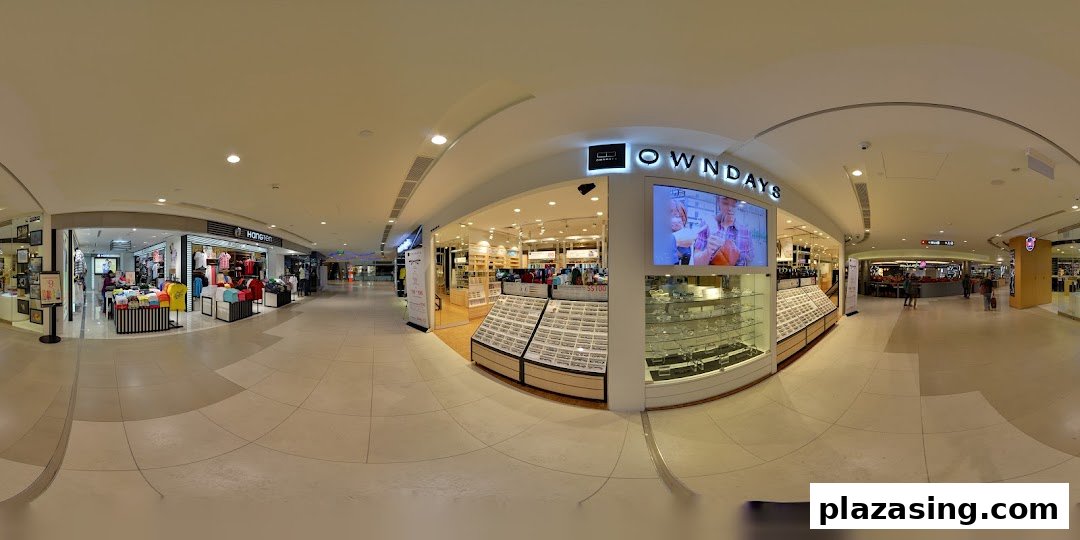 The bright and inviting storefront of OWNDAYS, an eyewear shop, within a bustling shopping mall.