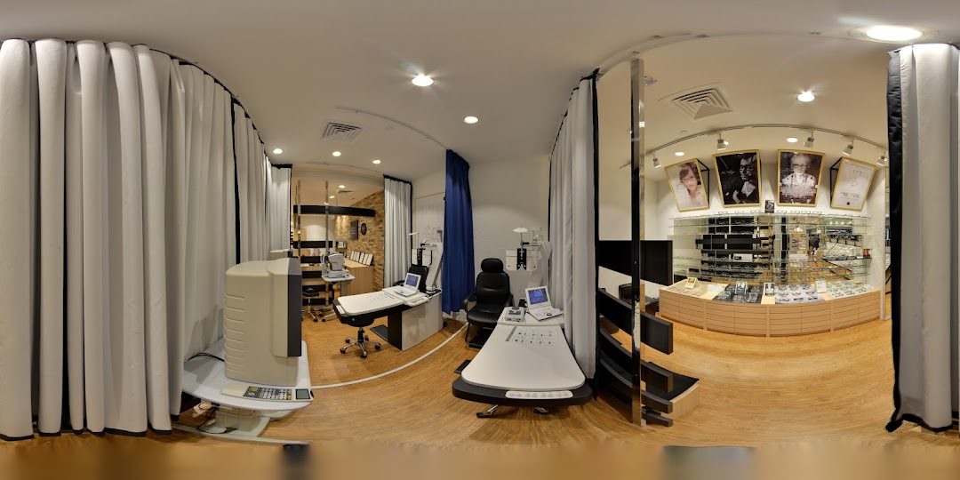 Interior view of OWNDAYS, showcasing eye examination equipment and extensive eyewear displays.