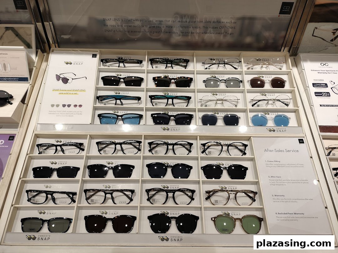 A display showcasing a wide selection of OWNDAYS SNAP eyeglasses and sunglasses with clip-on lenses.