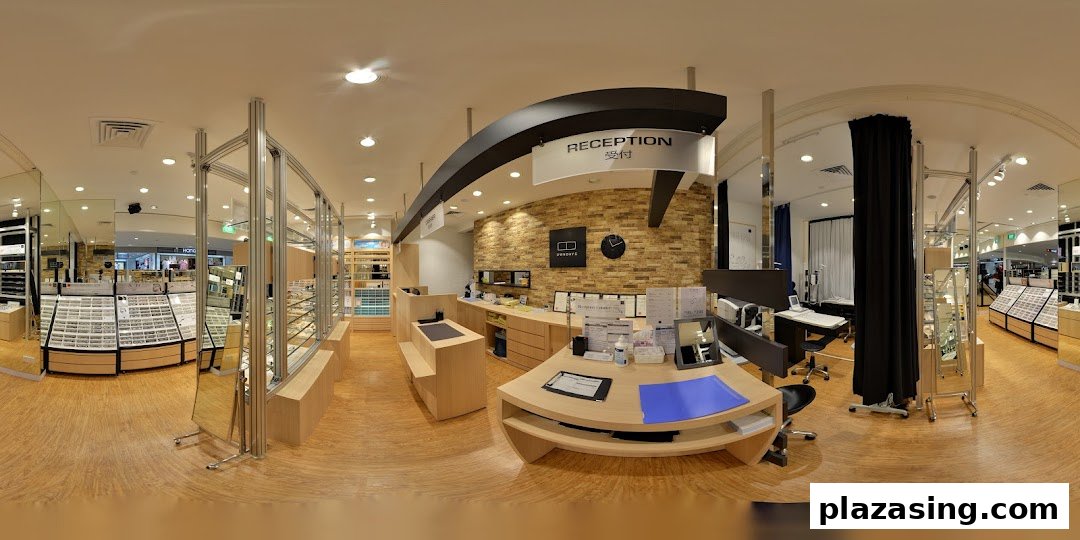 A panoramic view of OWNDAYS eyewear store interior, featuring the reception desk and extensive glasses displays.
