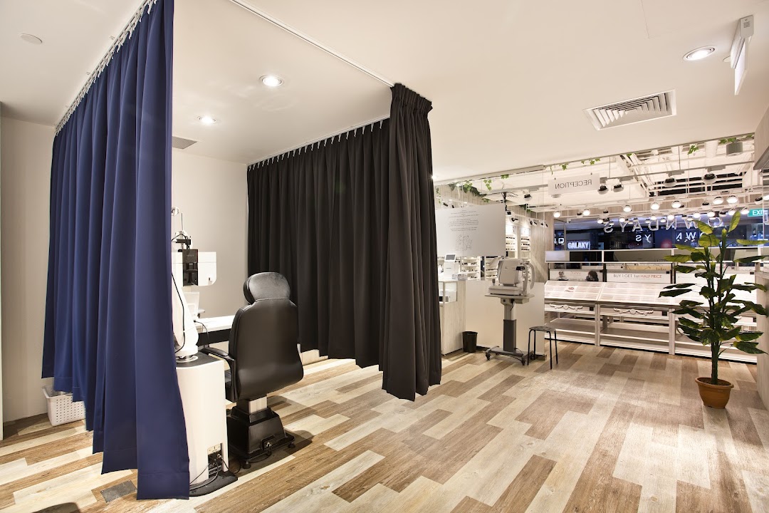Interior view of OWNDAYS, featuring a private eye examination area and a glimpse of the eyewear display.