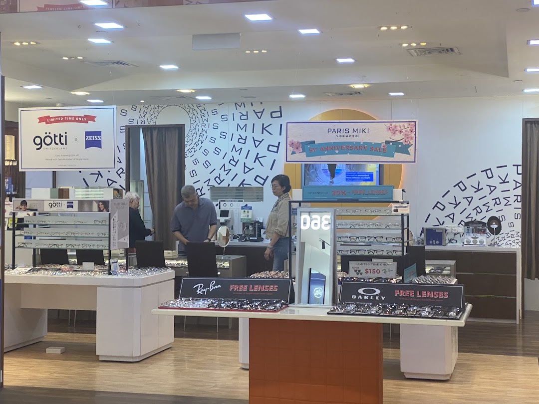 Customers browse a wide selection of spectacles and sunglasses at Paris Miki optical shop.