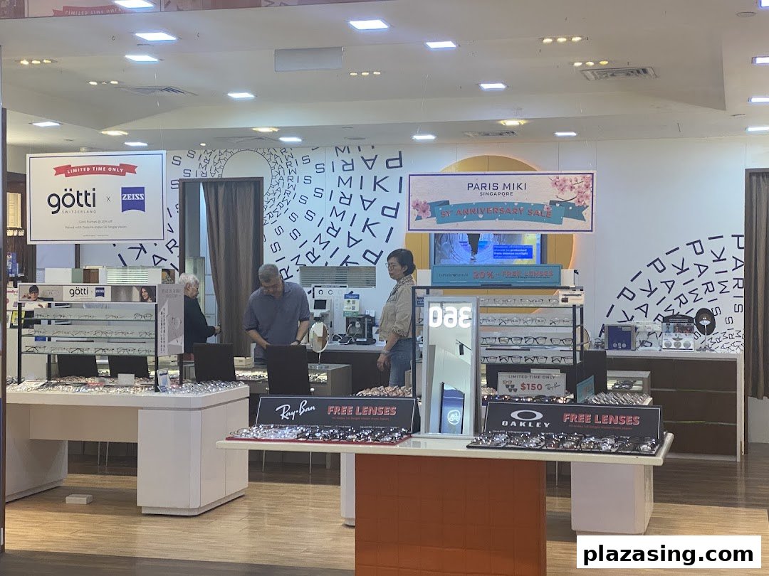 Customers browse a wide selection of spectacles and sunglasses at Paris Miki optical shop.