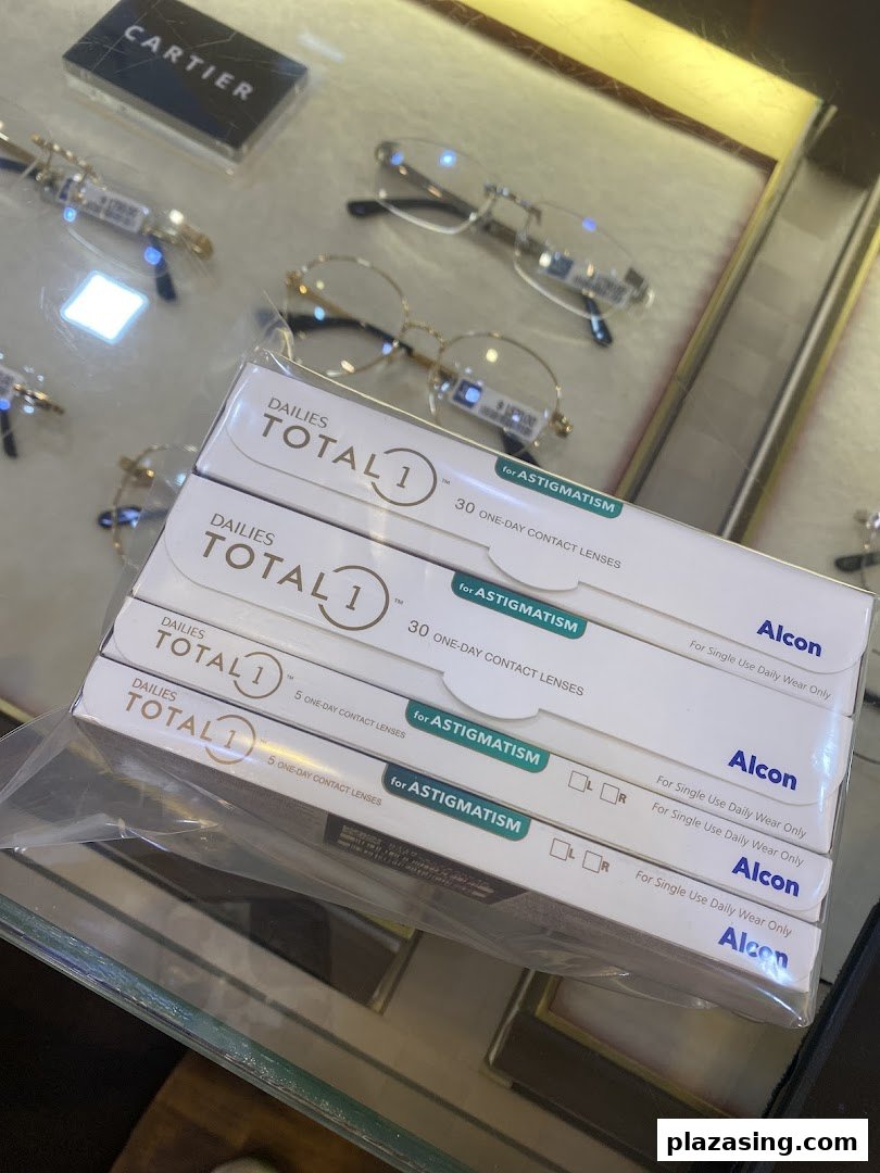 Boxes of Dailies Total 1 contact lenses and spectacles displayed in an optical shop.