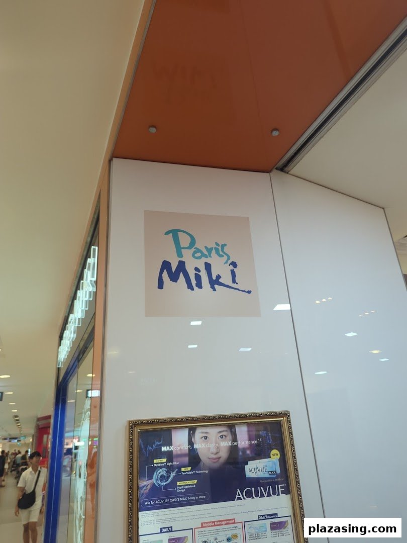 The exterior of Paris Miki optician, featuring its logo and an Acuvue contact lens advertisement.