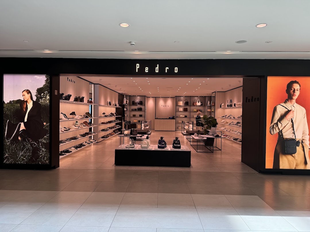 The inviting entrance of PEDRO showcasing a wide range of stylish shoes and accessories.