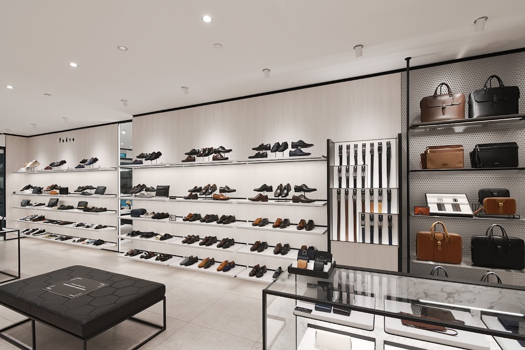 An interior view of PEDRO, showcasing a wide array of men's shoes, bags, and accessories on display.