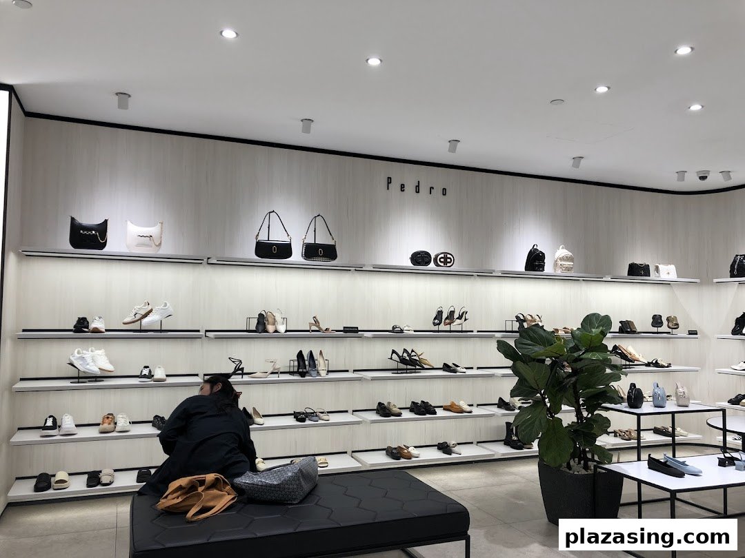 Interior view of PEDRO showcasing a wide array of stylish shoes and bags on display shelves.