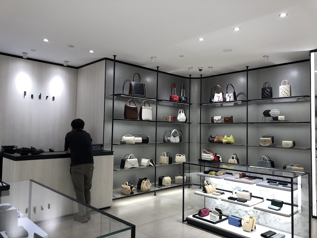 Interior view of PEDRO store showcasing a wide range of stylish bags and accessories on display shelves.