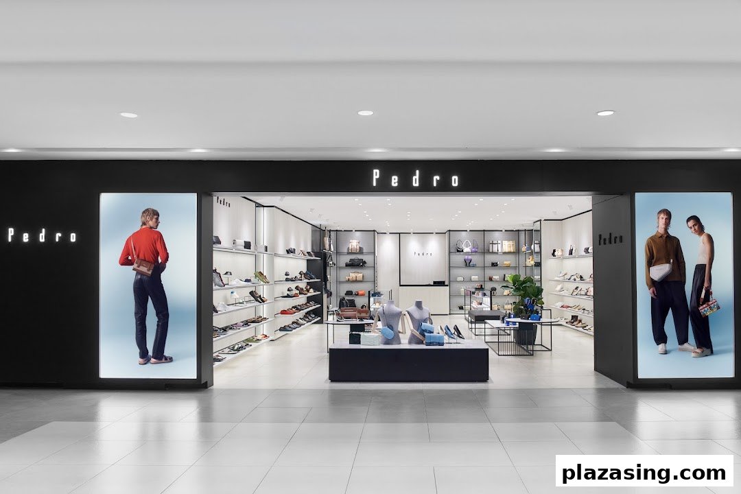 The modern storefront of PEDRO, showcasing stylish footwear and accessories with prominent display windows.