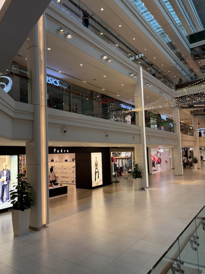 View of the PEDRO shop entrance and storefront within a brightly lit shopping mall.