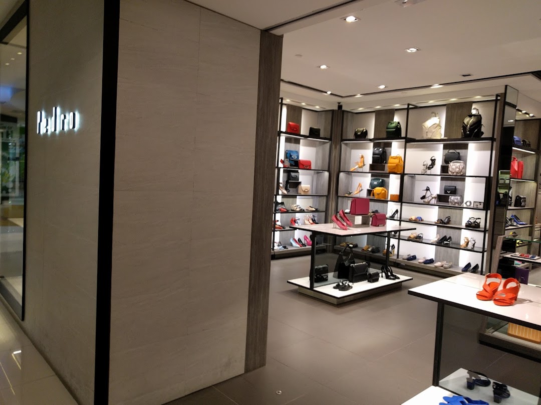 Interior view of PEDRO store showcasing a wide array of stylish shoes and handbags on display shelves.