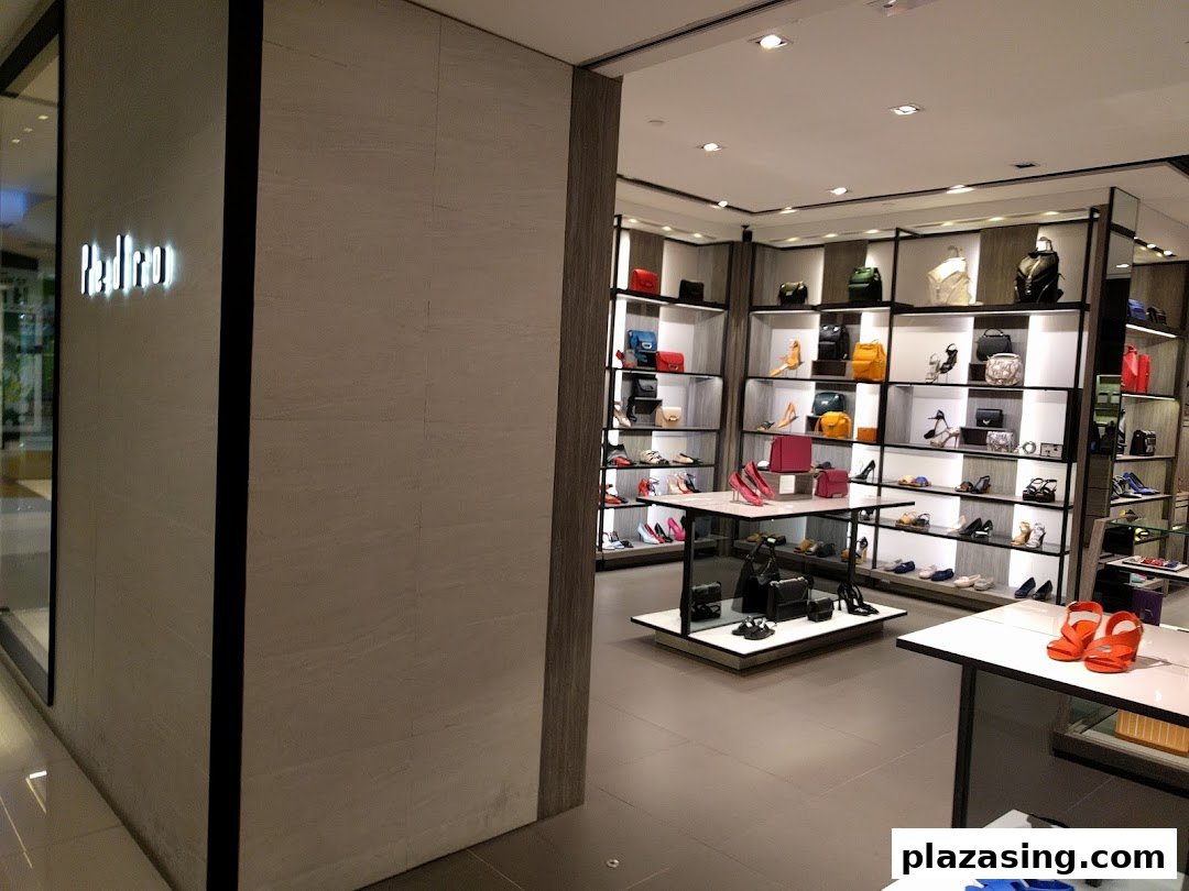 Interior view of PEDRO store showcasing a wide array of stylish shoes and handbags on display shelves.