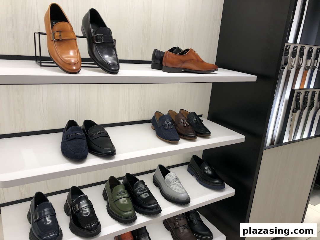 Shelves displaying a variety of stylish men's shoes and belts inside the PEDRO store.