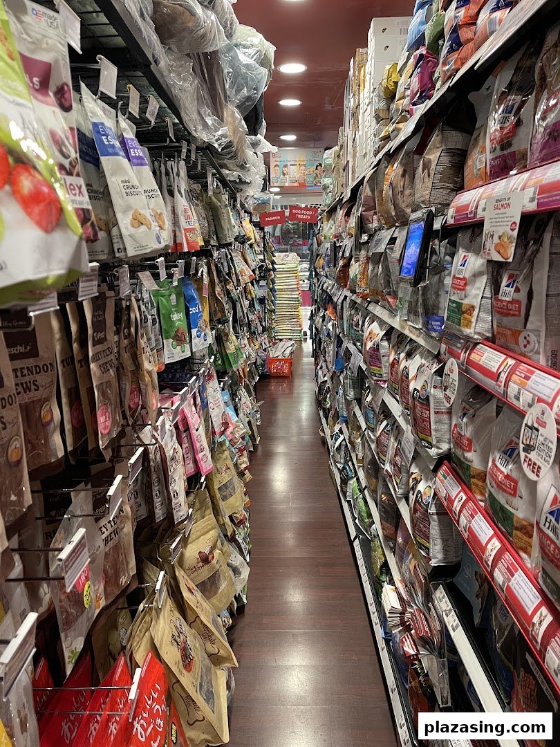 A long aisle in a pet store, fully stocked with various pet food and treat bags.