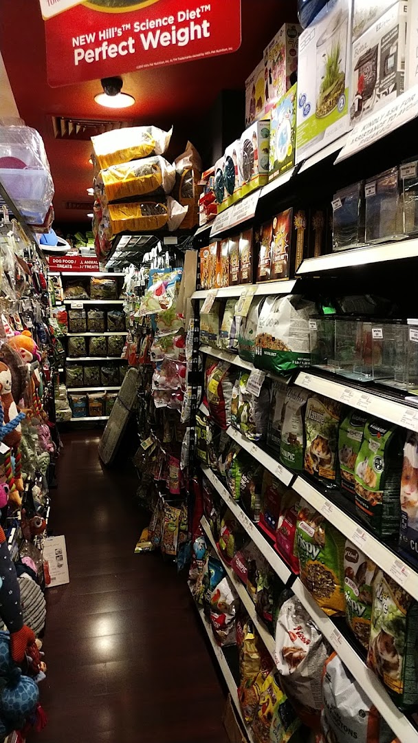 An interior view of Pet Lovers Centre, showcasing a well-stocked aisle of pet food and supplies.