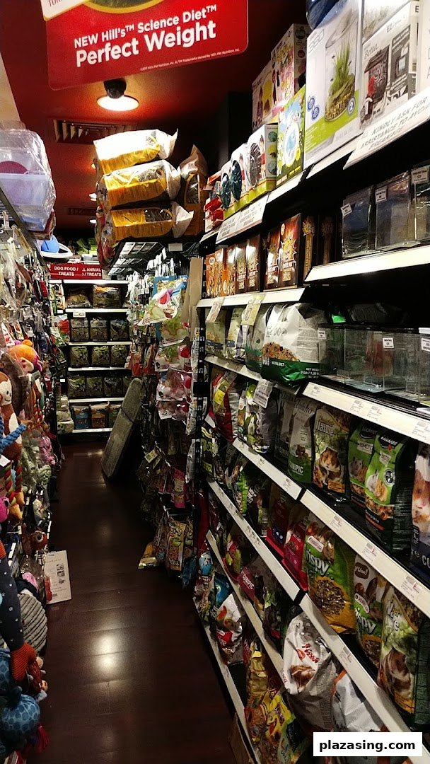 An interior view of Pet Lovers Centre, showcasing a well-stocked aisle of pet food and supplies.
