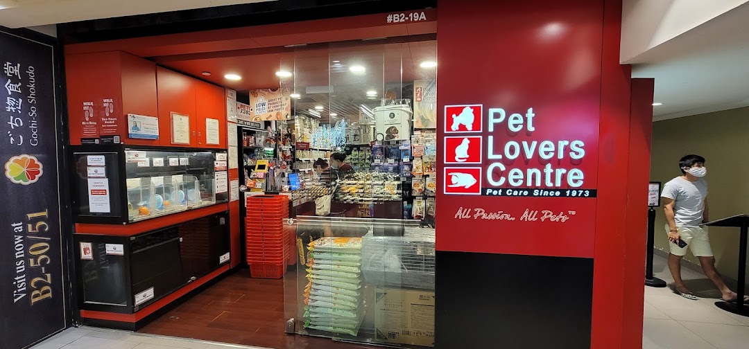 The vibrant red storefront of Pet Lovers Centre, a pet care shop, at Plaza Singapura.