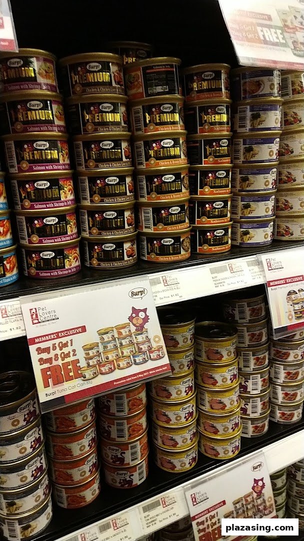 Shelves displaying various canned pet food products with visible pricing and member exclusive offers.