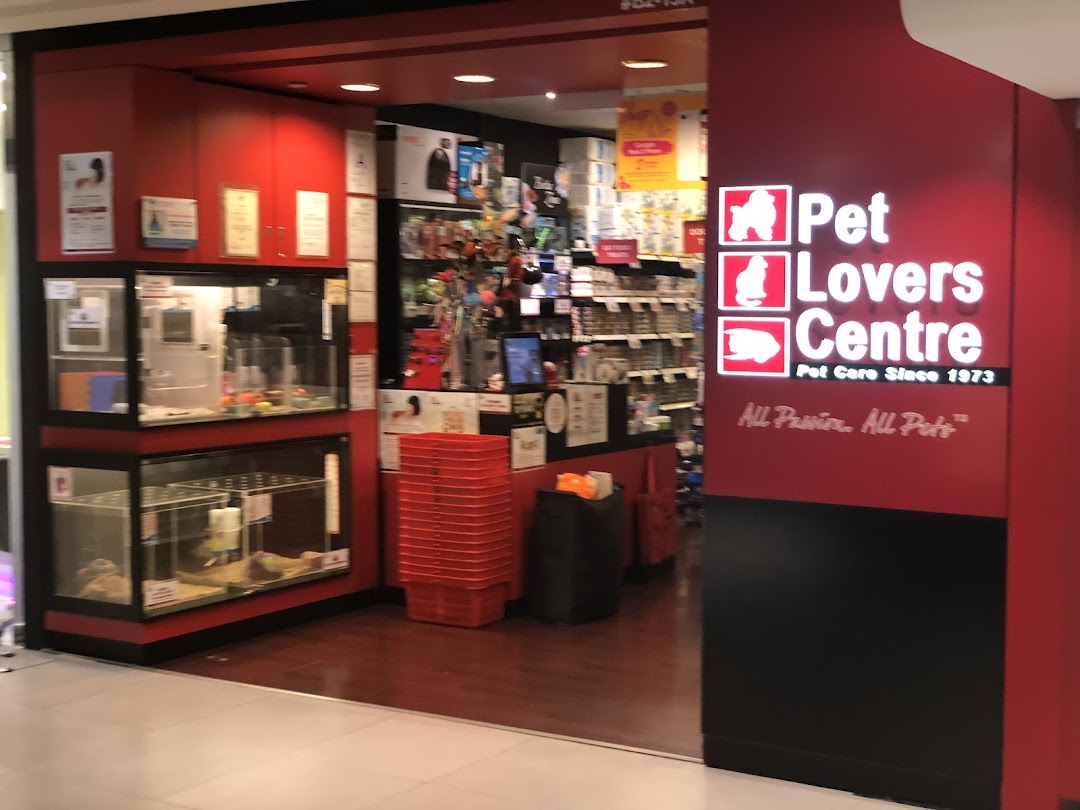 The vibrant red entrance of Pet Lovers Centre, showcasing pet enclosures and a wide array of pet products.