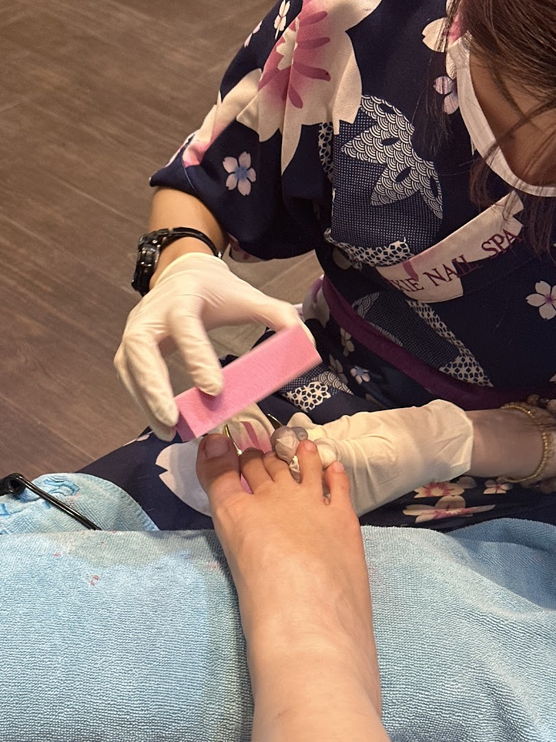 A skilled technician provides a meticulous pedicure service, filing a client's toenails at Pixie Nail Spa.