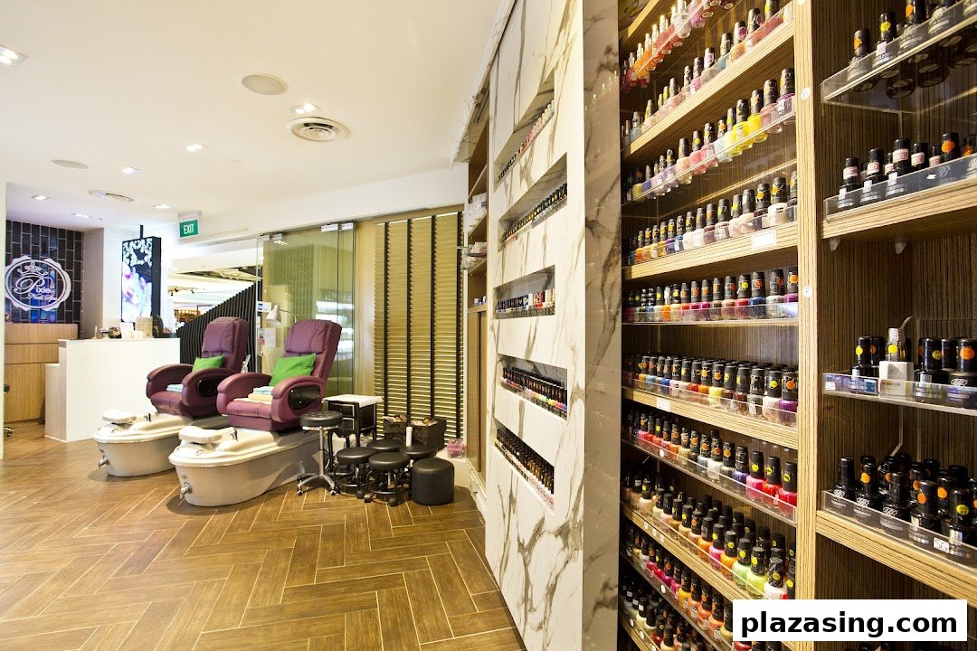 Interior view of a modern nail spa featuring comfortable pedicure stations and extensive nail polish displays.