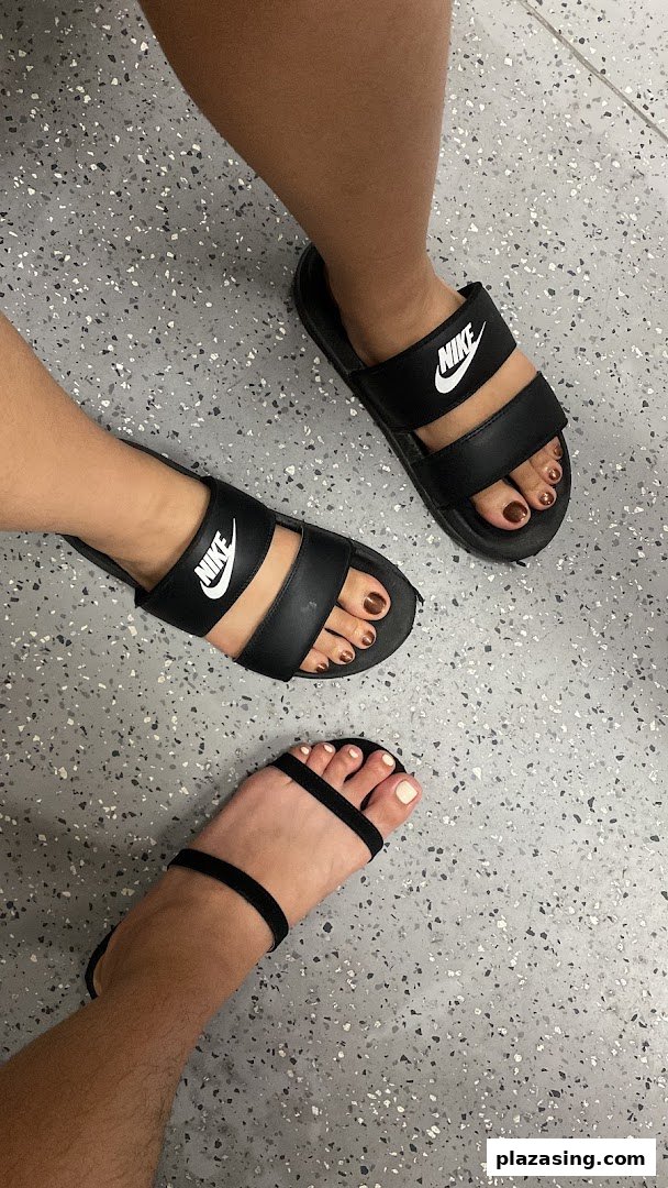 Close-up of three pairs of feet showcasing fresh pedicures with various nail polish colors.
