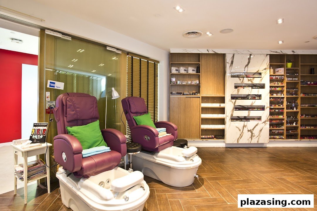 Interior view of a nail spa featuring two pedicure stations and extensive nail polish displays.