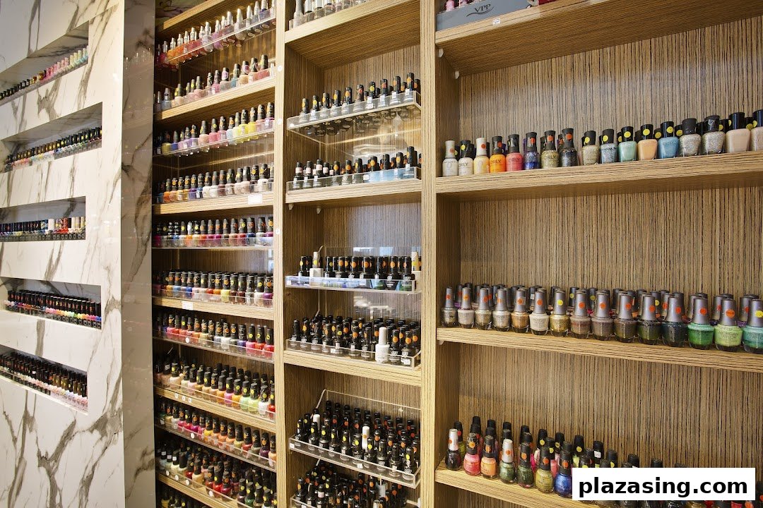 Extensive collection of colorful nail polishes displayed on shelves inside a modern nail spa.