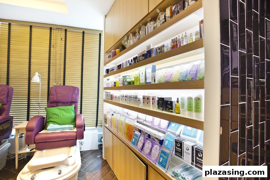 Interior view of Pixie Nail Spa, featuring a comfortable pedicure station and illuminated product display shelves.