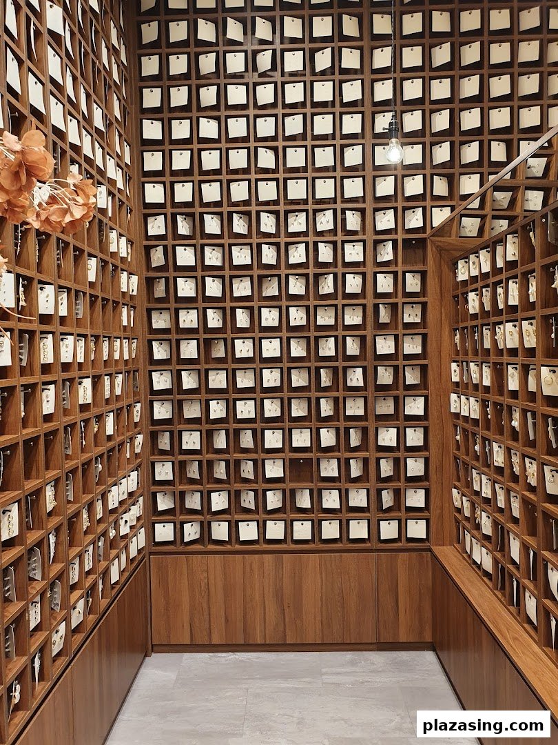 Interior view of Playdress showcasing a vast collection of earrings displayed in individual wooden cubbies.