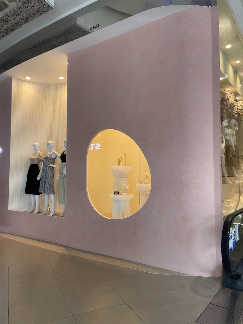 The shop front of Playdress Plaza Singapura featuring mannequins and accessory displays.