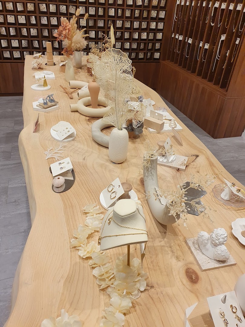 A stylish display table showcasing delicate jewelry and decorative items in a modern retail setting.