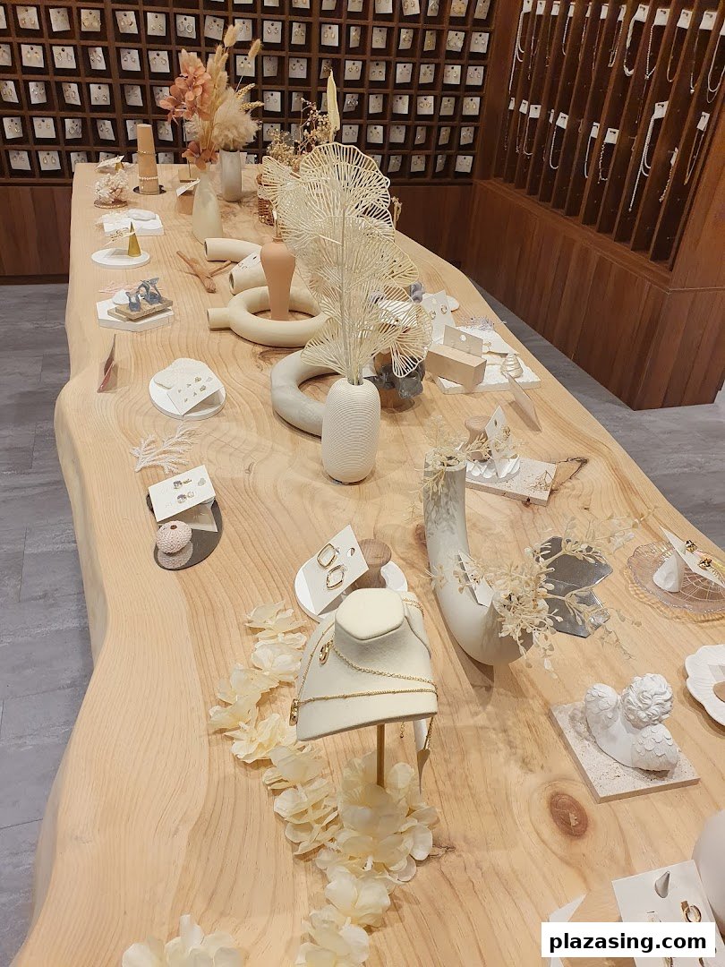 A stylish display table showcasing delicate jewelry and decorative items in a modern retail setting.