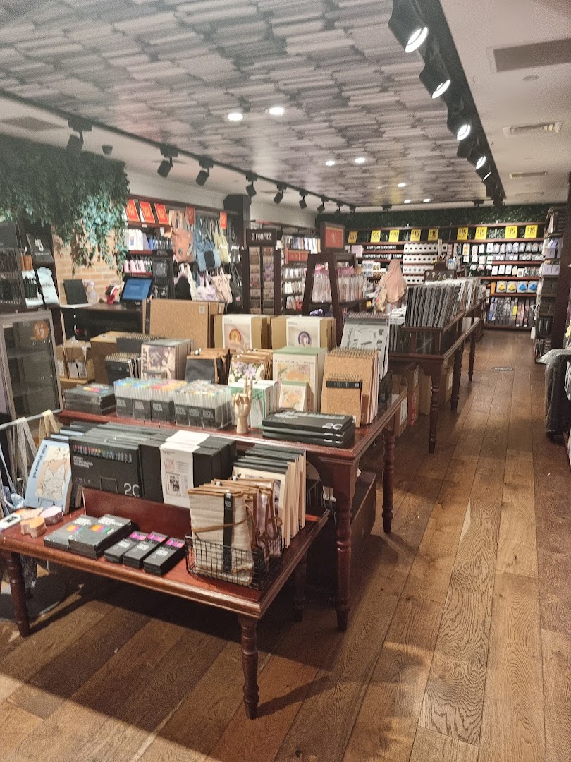 Interior view of Typo, showcasing stationery, gifts, and creative supplies on display tables and shelves.