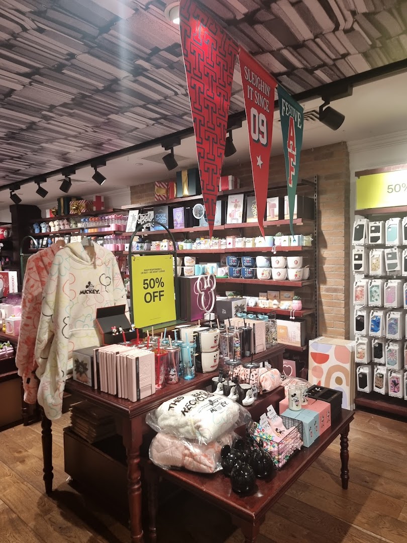 Interior view of Typo showcasing various stationery, gifts, and Mickey Mouse merchandise with a 50% off sale.