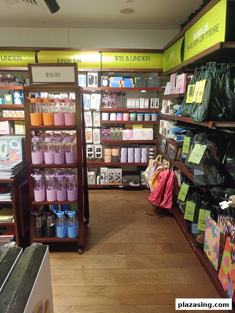 An interior view of Typo, showcasing colorful stationery, drinkware, and gift items on display shelves.