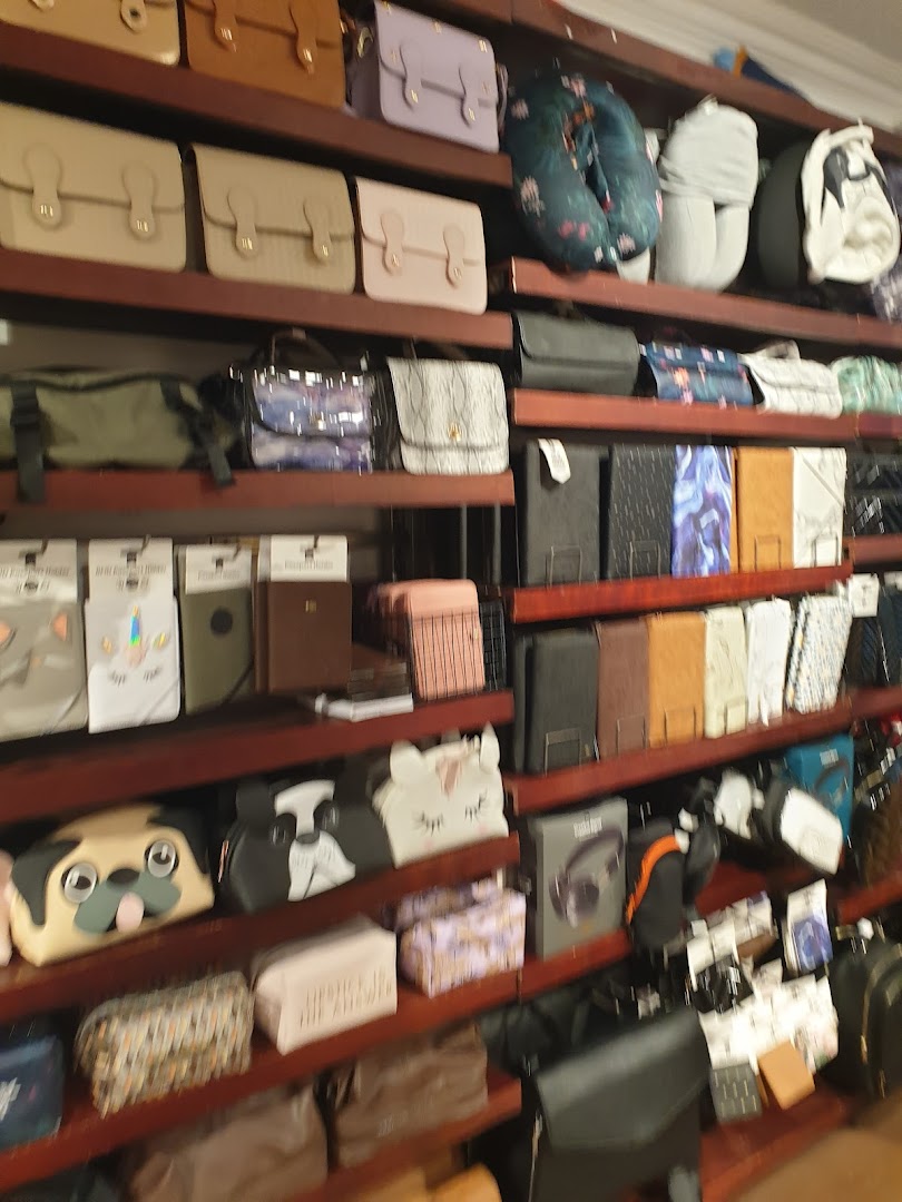 Shelves filled with a diverse collection of bags, pouches, and accessories in a retail store.