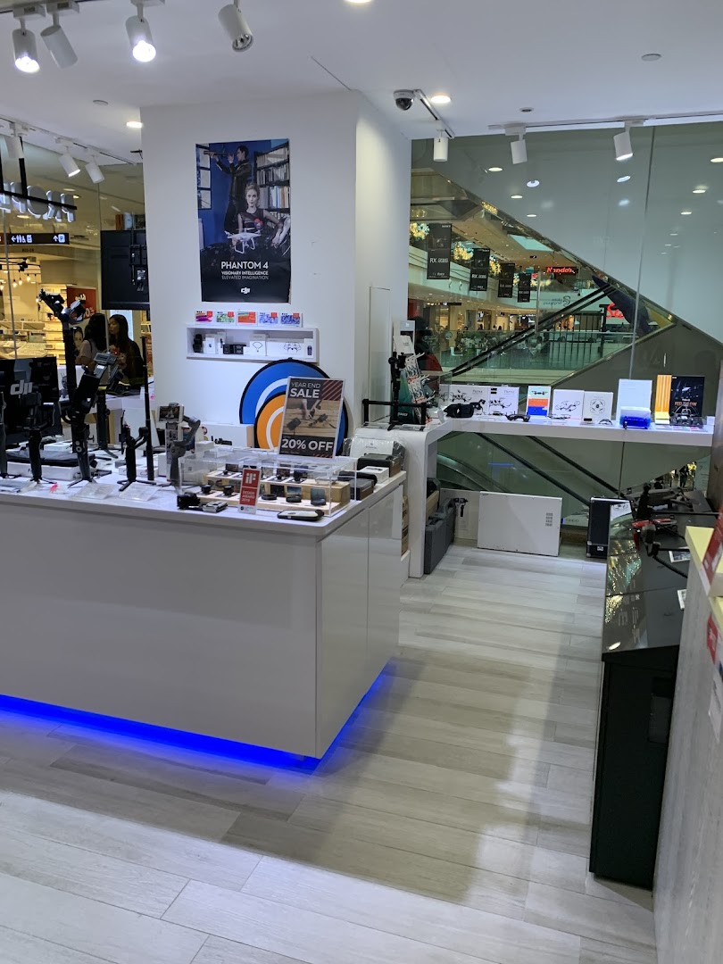 Interior view of Propeller Singapore, a modern electronics store showcasing drones, gimbals, and tech accessories.