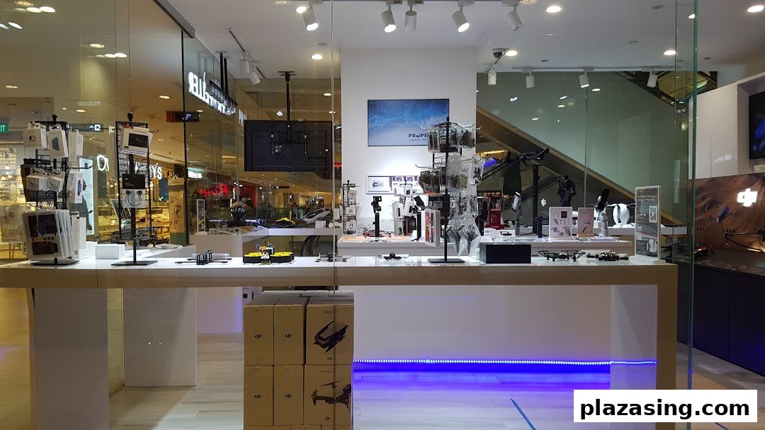 A modern retail store interior showcasing drones, accessories, and tech gadgets on display.