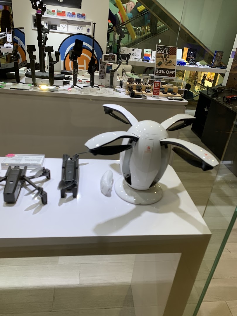 A retail display showcasing drones, camera gimbals, and other tech accessories.