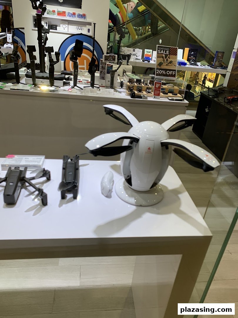 A retail display showcasing drones, camera gimbals, and other tech accessories.