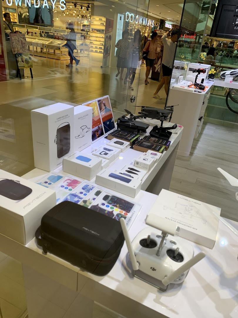 A display of drones, drone accessories, and remote controls inside Propeller Singapore.